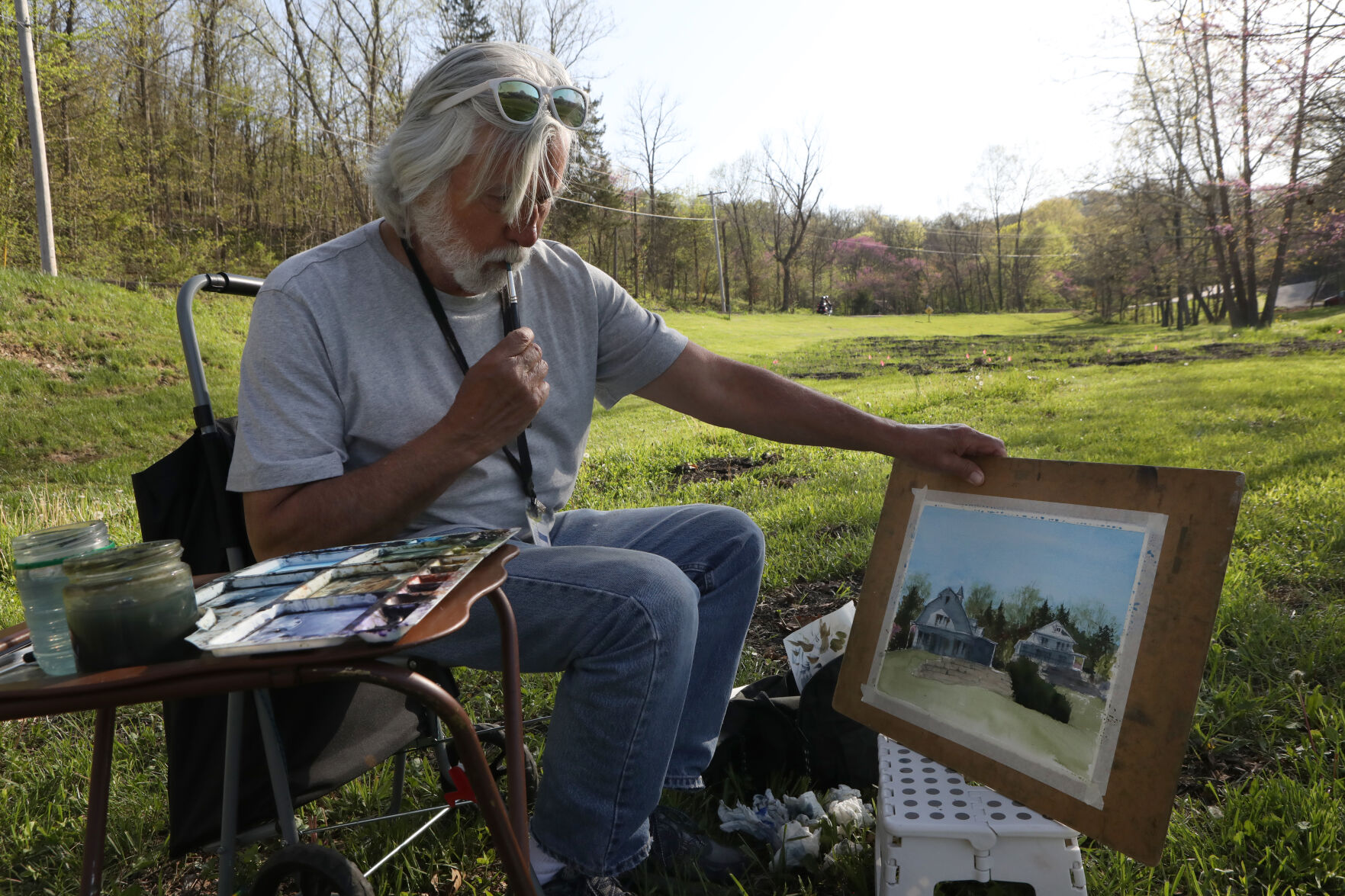 Denny Dowdy contemplates his painting